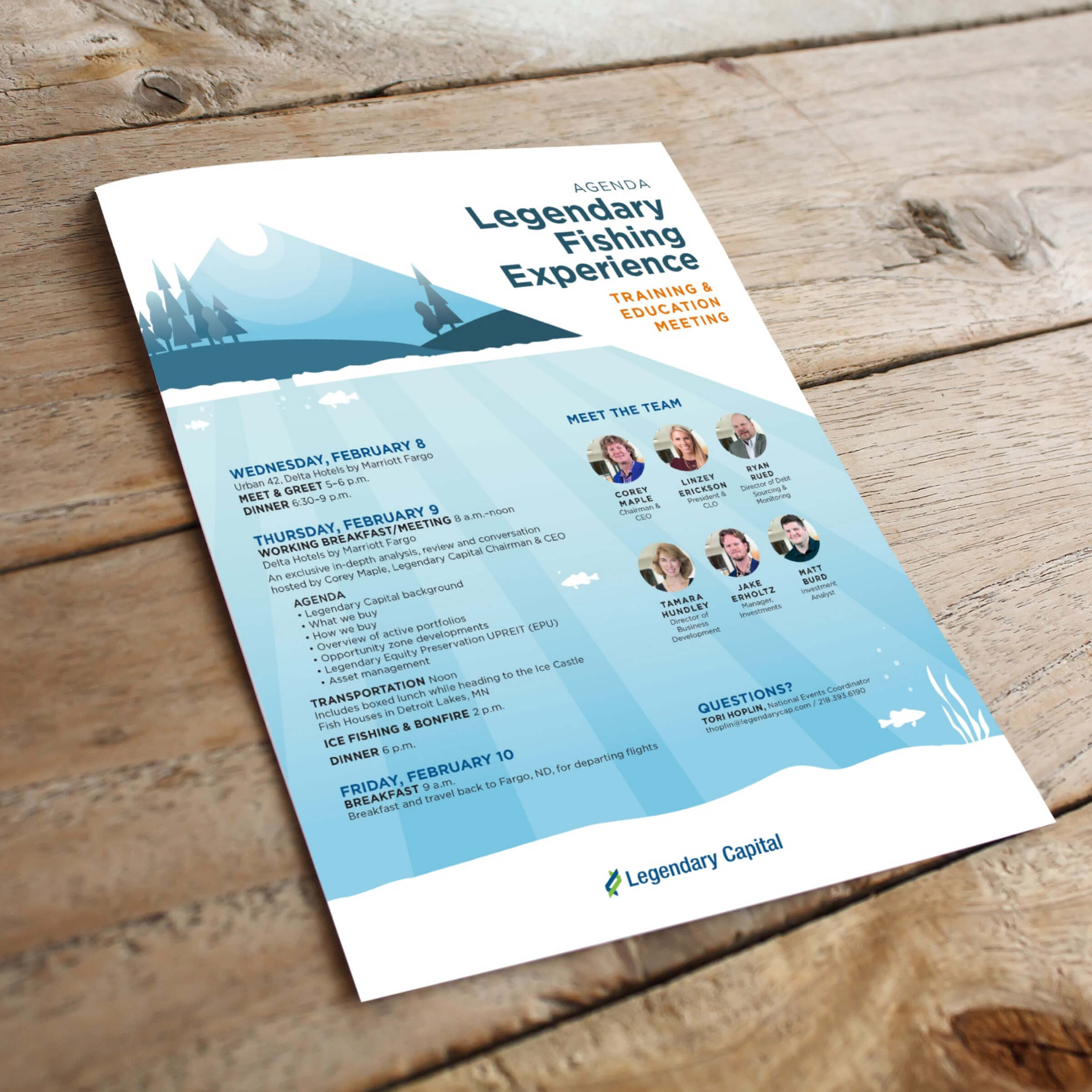 A blue and white agenda laying on a wooden table.