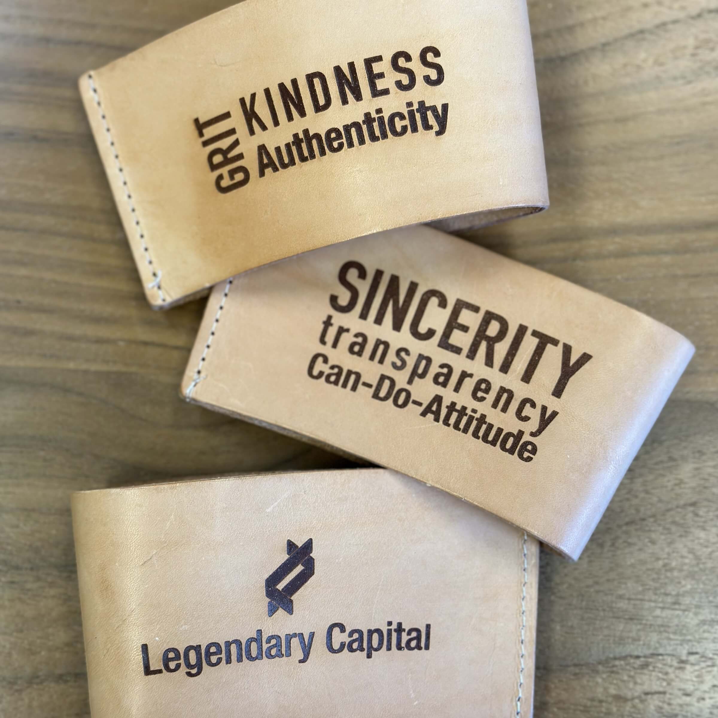 Light leather koozies with typographical phrases.