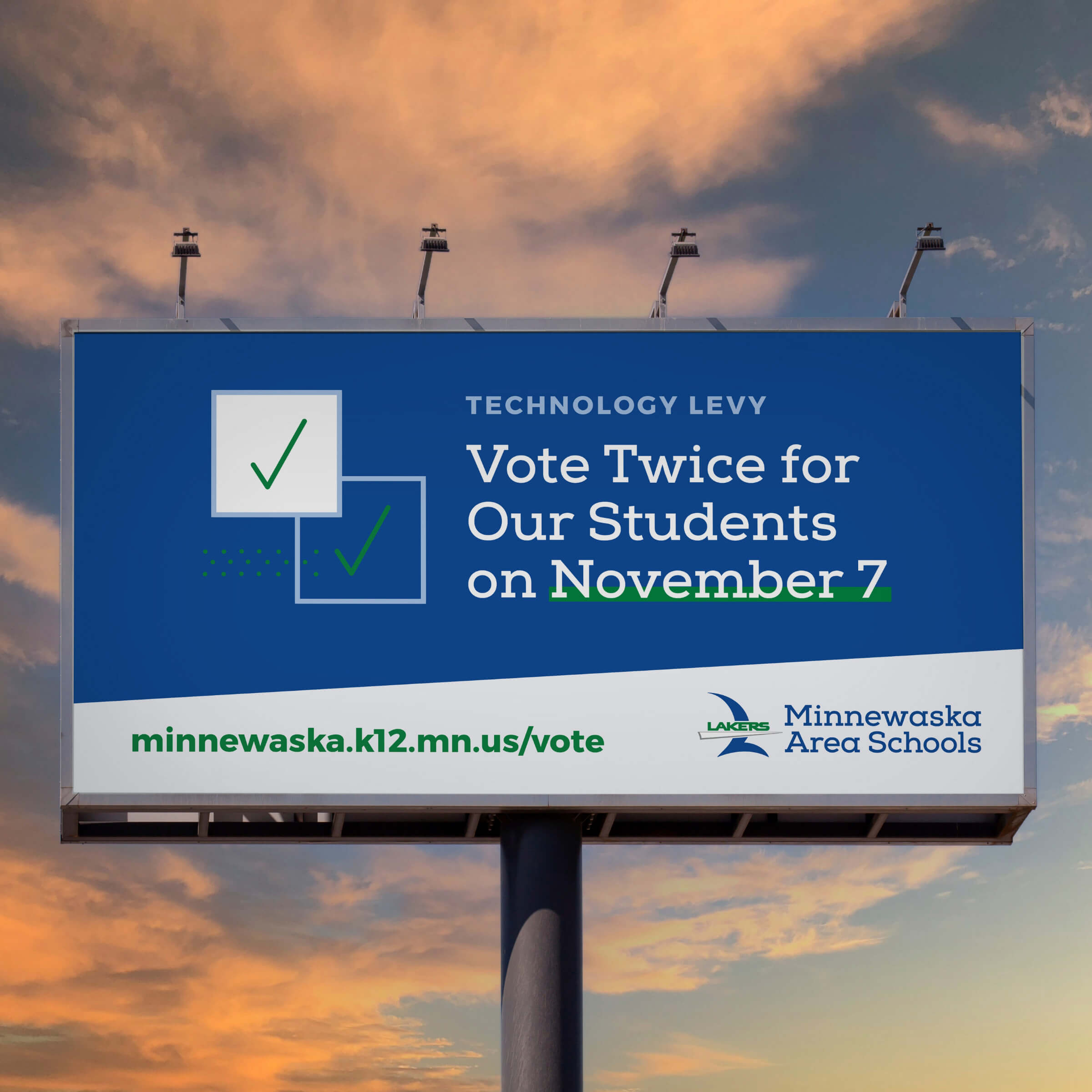 A school billboard with a sunset in the background.