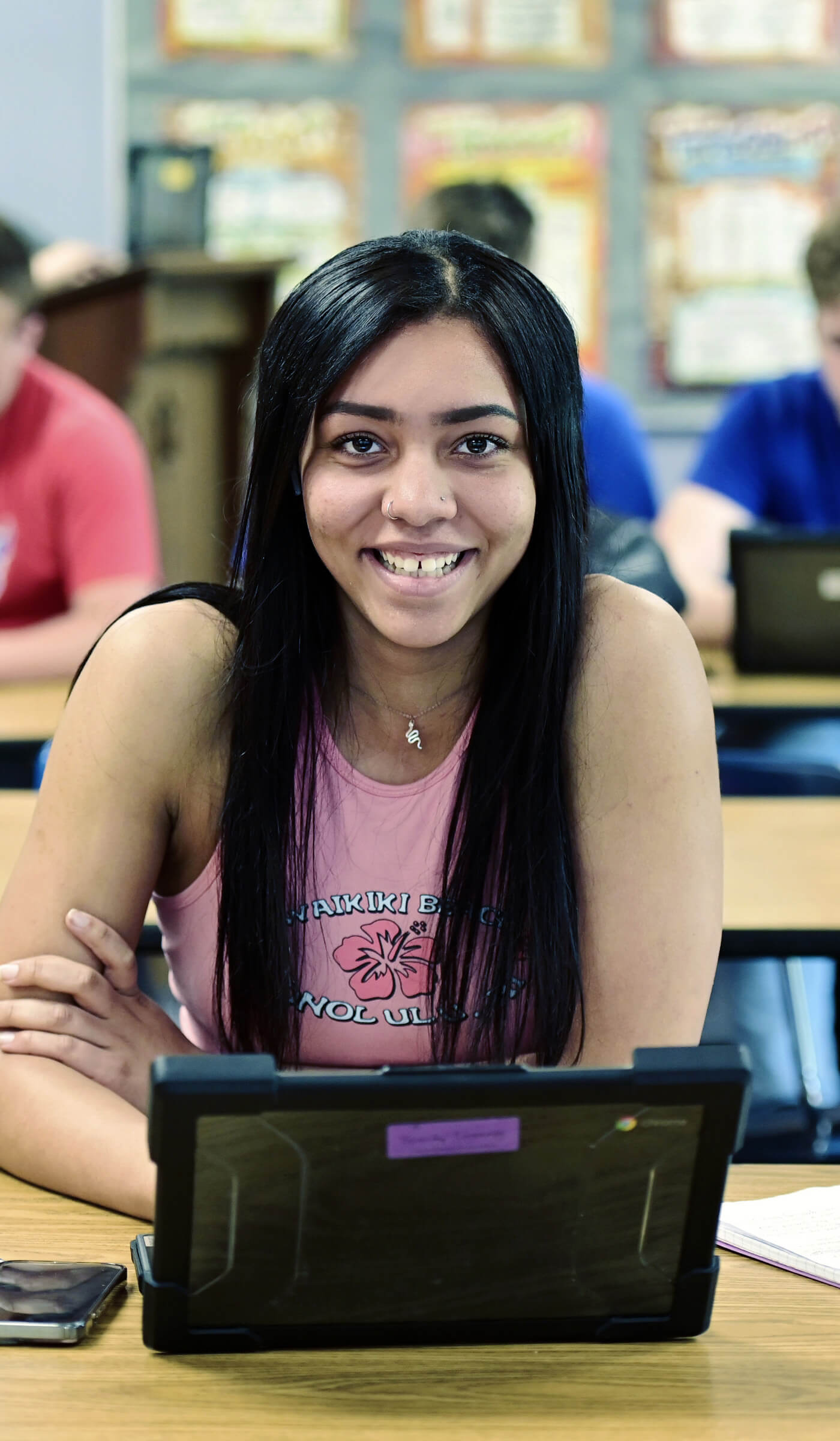 A high school student with a laptop.