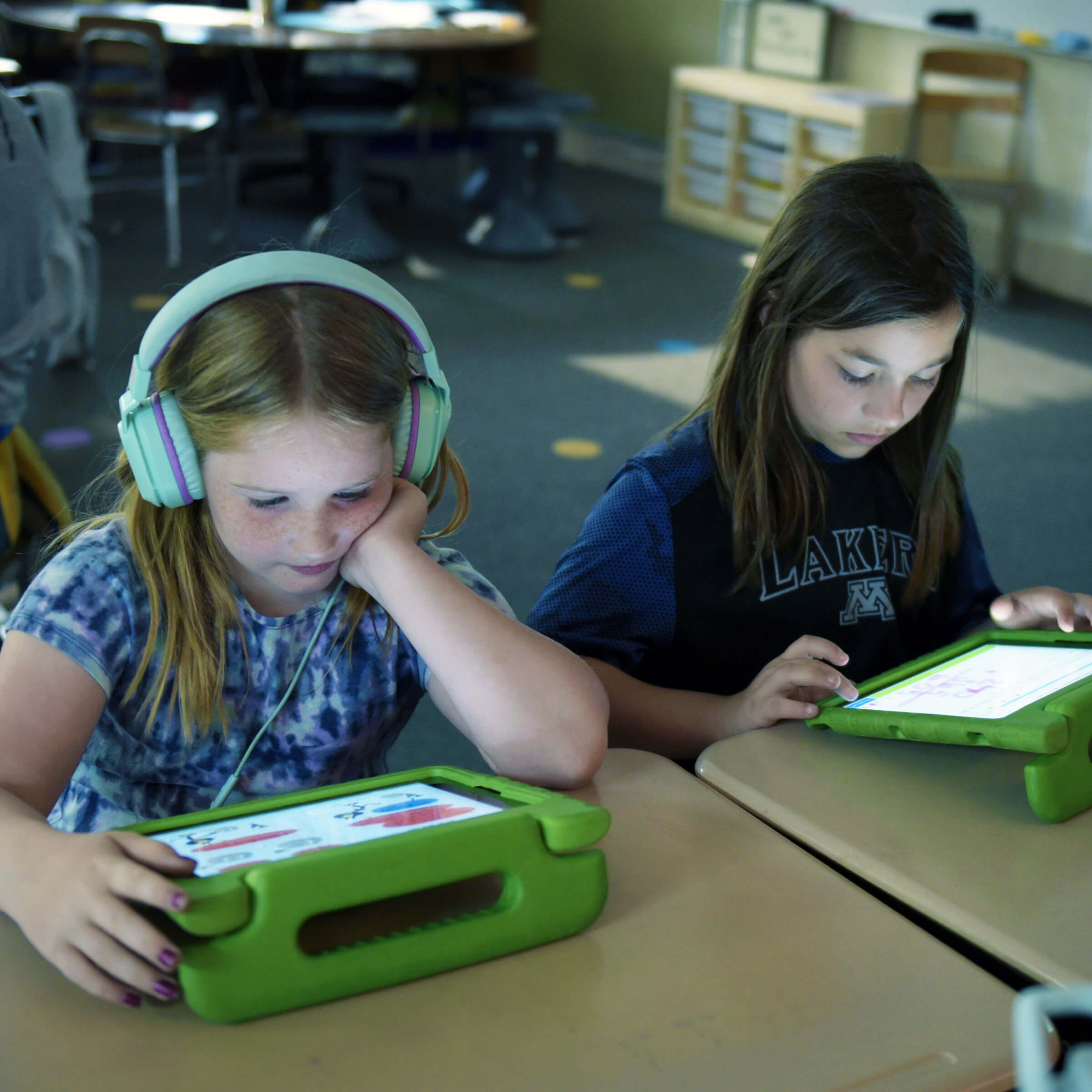 Two students using tablets.
